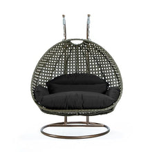 LeisureMod Black Wicker 2 Person Egg Swing Chair with Beige Stand and Cushions – Double Hanging Hammock Lounge for Patio, Indoor & Outdoor Use