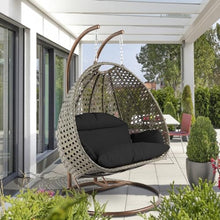 LeisureMod Black Wicker 2 Person Egg Swing Chair with Beige Stand and Cushions – Double Hanging Hammock Lounge for Patio, Indoor & Outdoor Use
